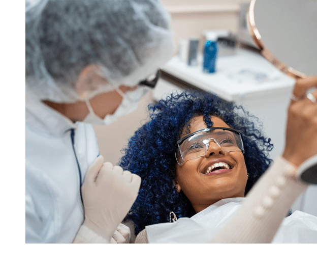 stock image of patient seeing her teeth in mirror with doctor