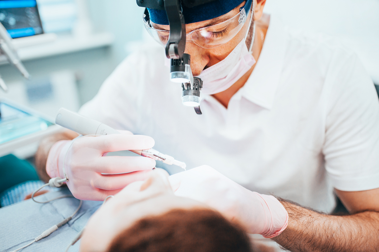 Image of a dentist working on a patient to visually describe what to expect of root canal procedure.
